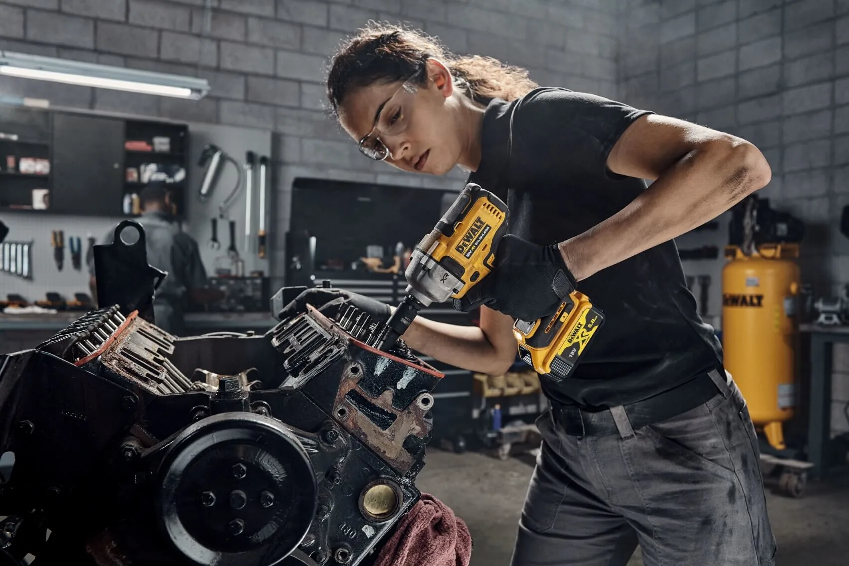 DeWalt DCF892NT Akku-Schlagschrauber im Einsatz am Motor in der Werkstatt (Mechanikerin)