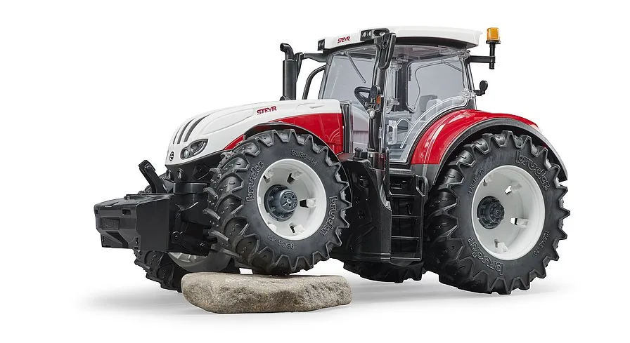 Geländegängige Pendelvorderachse des Bruder Steyr Traktors auf unebenem Grund