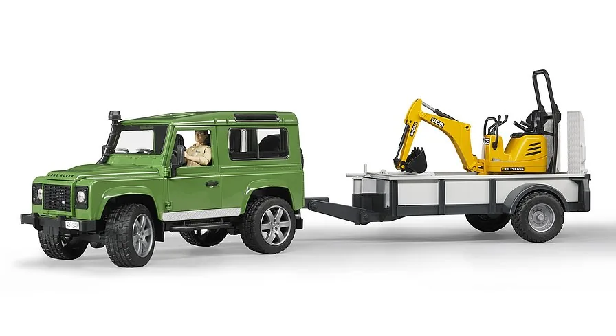 Abfahrbereites Gespann: Land Rover Defender zieht den JCB Bagger auf dem Einachsanhänger